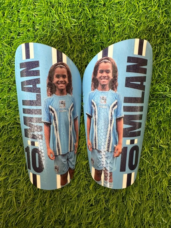 Elite personalised shin pads young girl with light blue backdrop.
