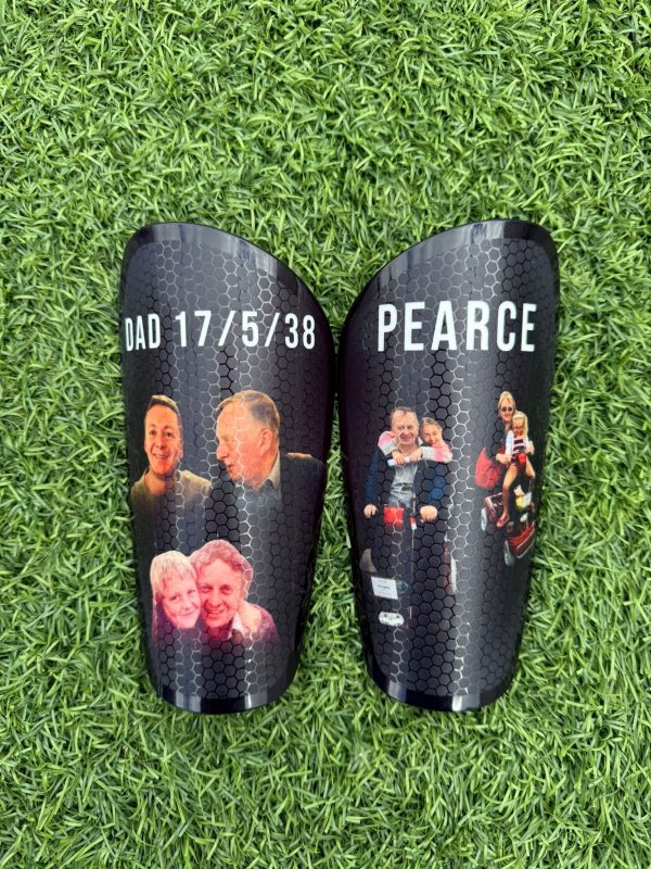 Elite personalised shin pads with black background, team and family images.