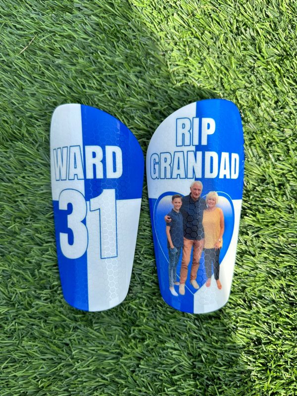 Elite personalised shin pads with blue and white squared background and grandad image.